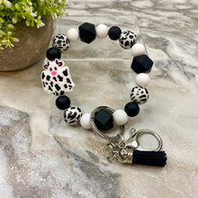 Load image into Gallery viewer, Silicone Bracelet Keychain with Tassel - Cow - Black
