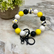 Load image into Gallery viewer, Silicone Bracelet Keychain - Black Yellow White Daisy
