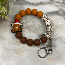 Load image into Gallery viewer, Silicone Bracelet Keychain -  Christmas Brown Highland Cow
