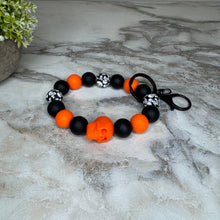Load image into Gallery viewer, Silicone Bracelet Keychain - Halloween Skull - Orange
