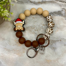 Load image into Gallery viewer, Silicone Bracelet Keychain -  Christmas Beige Highland Cow
