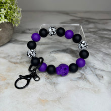 Load image into Gallery viewer, Silicone Bracelet Keychain - Halloween Skull - Purple

