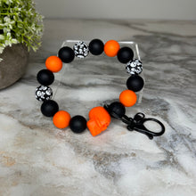 Load image into Gallery viewer, Silicone Bracelet Keychain - Halloween Skull - Orange
